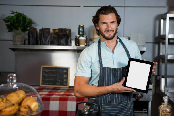 istock Male staff holding a digital tablet in coffee shop 657265000