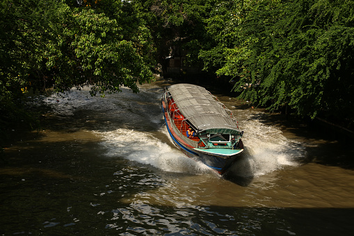 Bangkok, Thailand - November 15 2016: A river boat is seen on a  'klong' (canal) in Bangkok, Thailand
