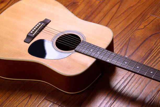 istock Acoustic Guitar on Wood Background 657274038