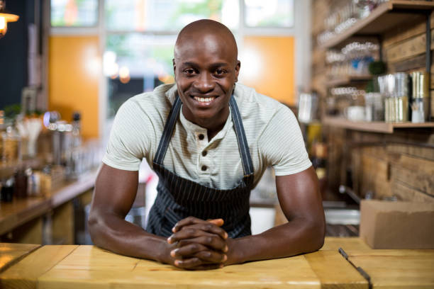 istock Portrait of waiter standing at counter 657276796