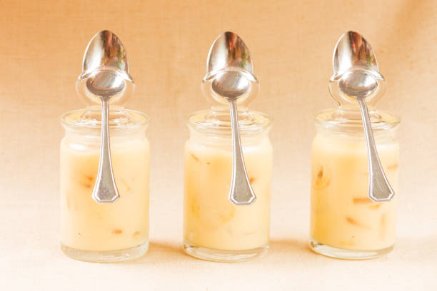 Banana pudding in the glass jars in a row. Horizontal