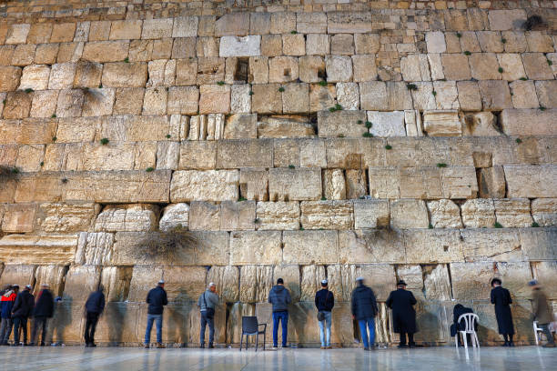 Daily Prayer at Western Wall, Old City, Jersalem, Israel Jerusalem, Israel - January 25, 2017: Praying at the Western 'Wailing' Wall of Ancient Temple in Jerusalem, Israel. Western wall of the Ancient Jewish Temple built in 100BC by Herod the Great on the Temple Mount. Judaism's most holy site. hasidism photos stock pictures, royalty-free photos & images