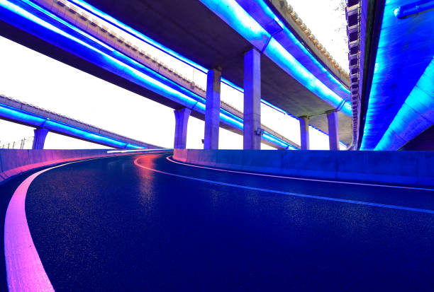 istock Empty road floor with city viaduct bridge of neon lights night 657277828