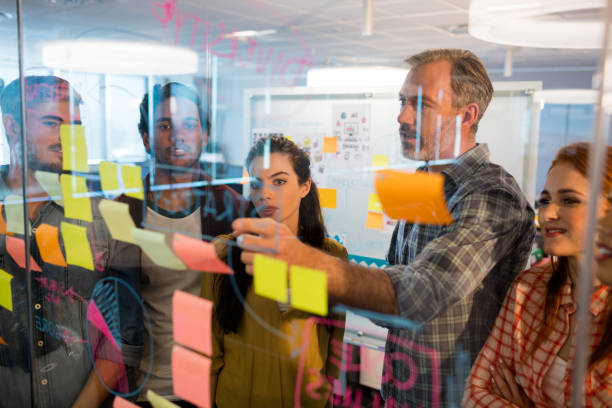 istock Creative business team looking at sticky notes on glass window 657280566
