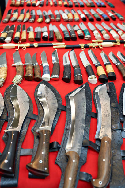 Hunting knives and machete on red