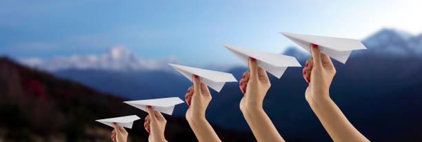 istock Paper plane holding by hand on Everest mountain view blur background 657281002