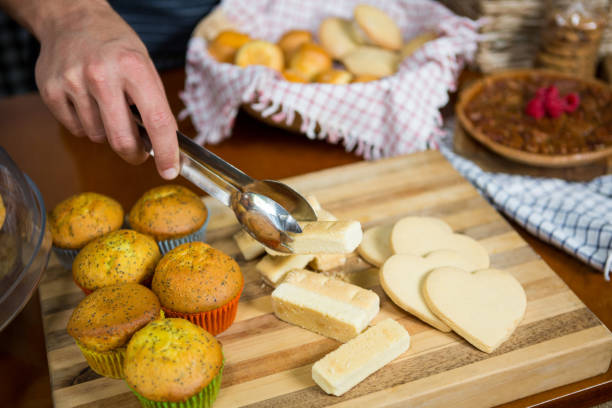 istock Staff holding cookies with tong in bakery shop 657287452