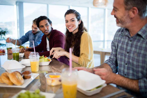 istock Creative business team having meal in office 657293576