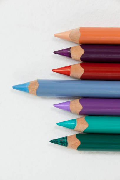 istock Blue pencil standing out from a row of colored pencils 657301476