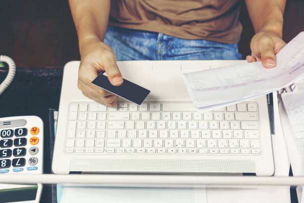 istock Young man using credit card for paying bills on laptop 657304582