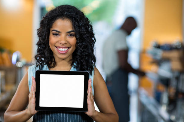 istock Portrait of smiling waitress showing digital tablet 657307118