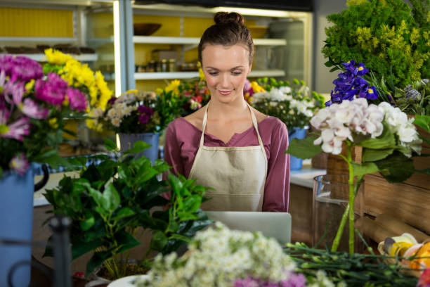 istock Florist using laptop in flower shop 657307154