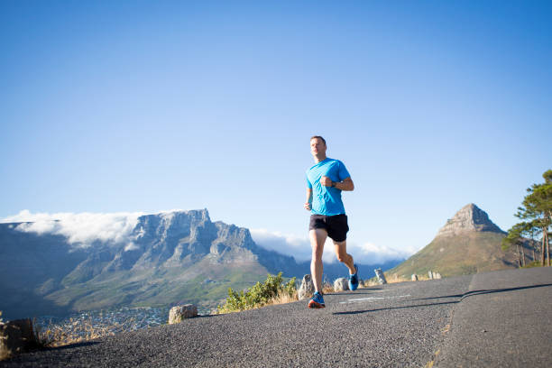 istock Low angle view of a male running along a road 657307202