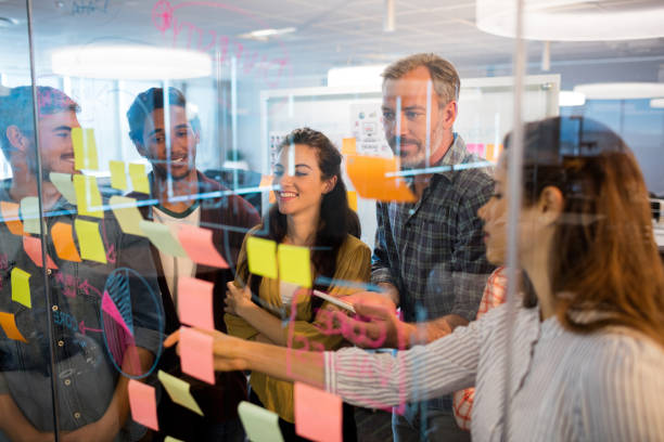 istock Creative business team looking at sticky notes on glass window 657314652