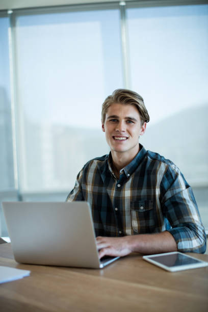 istock Smiling man working on laptop in office 657314864