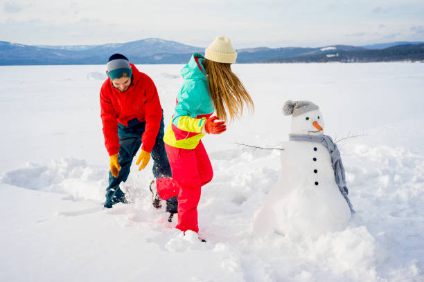 istock Happy couple playing snowballs 657317400