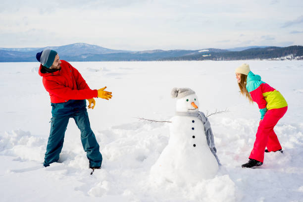 istock Happy couple playing snowballs 657317412