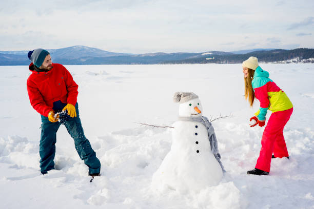istock Happy couple playing snowballs 657317420