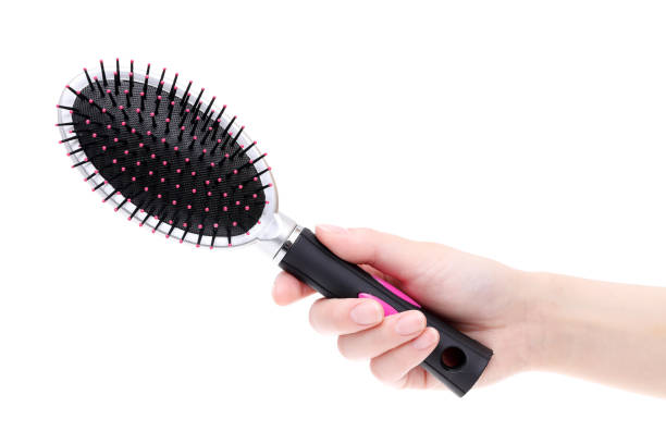 istock Hand holding hair brush 657323972