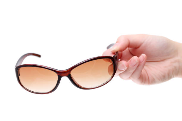istock Hand holding ladies brown sunglasses 657324096