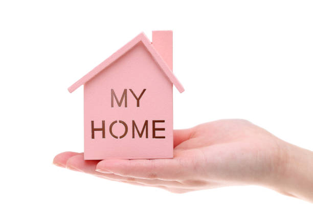 istock Miniature model of house on the hand 657324132
