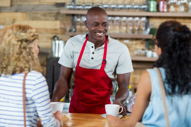 istock Waiter serving coffee to female customer 657327224