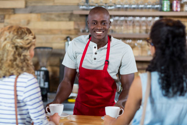 istock Waiter serving coffee to female customer 657327274
