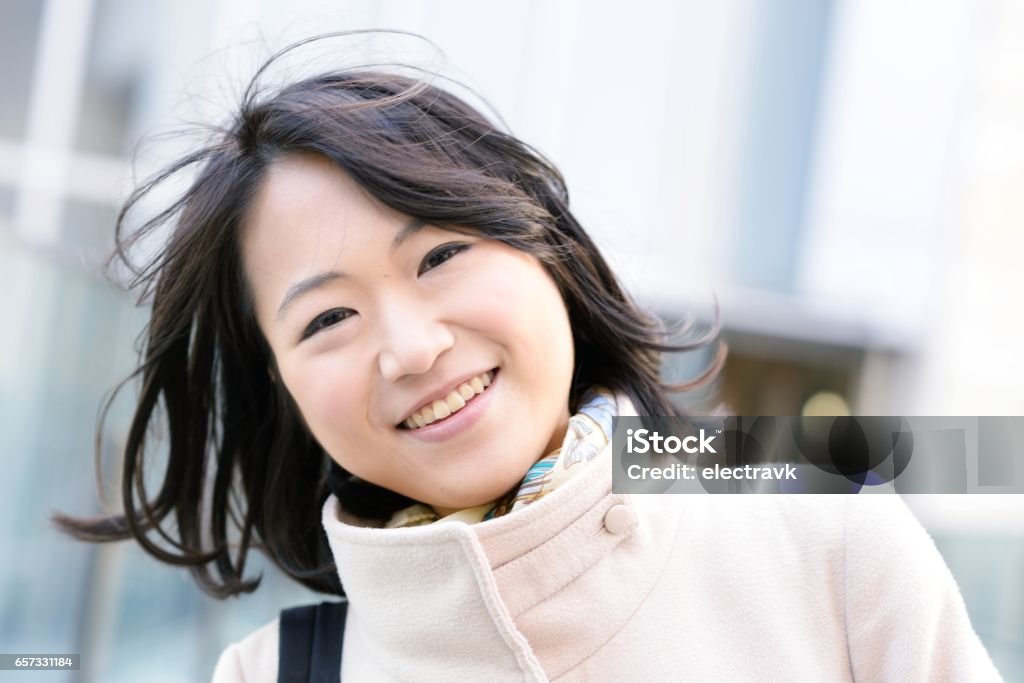 Confident and cheerful young woman A young woman looking at the camera confidently. 20-29 Years Stock Photo