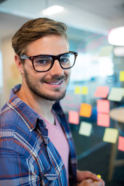 istock Man in office standing near the wall with sticky notes 657331222