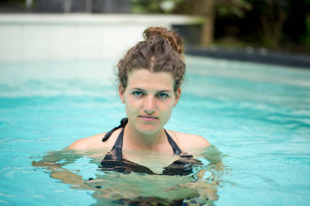 istock Content Young Woman Swimming in Pool 657335956