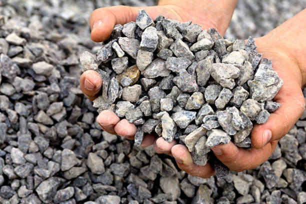 Gravel on hand. Men's strong arms holding a bunch full of rubble gravel stock pictures, royalty-free photos & images
