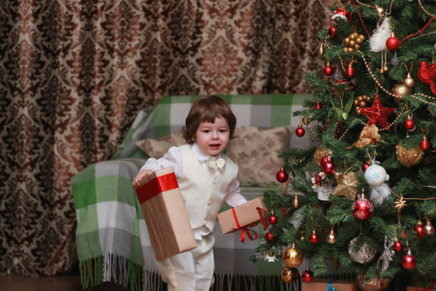 istock child decorate the Christmas tree toy 657342370