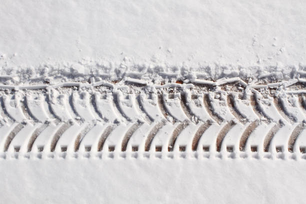 istock Close up car tire track in fresh snow 657342478
