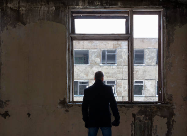 istock Silhouette of man, looking over the abandoned building 657345560