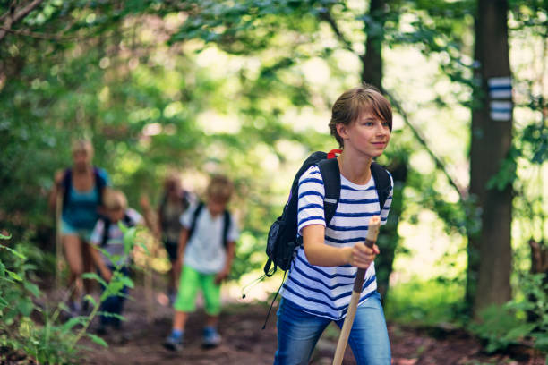 istock Family hiking in a green forest 657346908