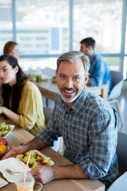 istock Smiling man having meal with his colleagues 657351004