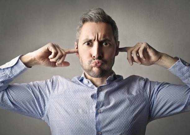 I don't want to hear it Man is covering his ears with his fingers, because he don't want to hear anything plastination photos stock pictures, royalty-free photos & images