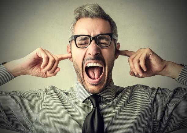 I don't want to hear it Man in glasse creaming while covering his ears, because he don't want to hear anything plastination photos stock pictures, royalty-free photos & images