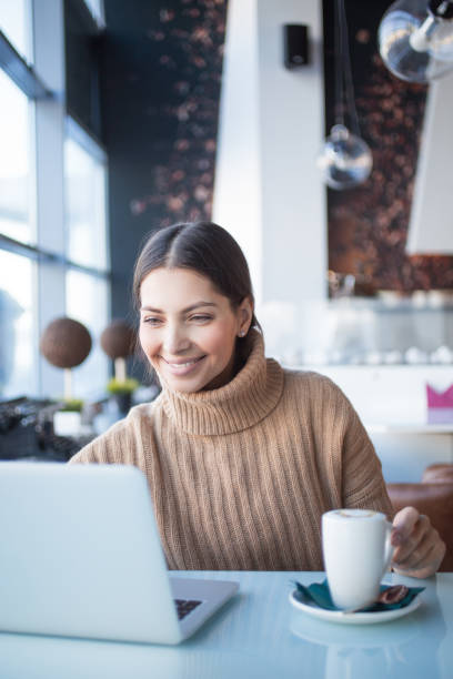 istock Cheerful woman using laptop in coworking space 657360024