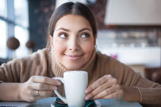 istock Dreamful funny woman with mug looking up 657360064