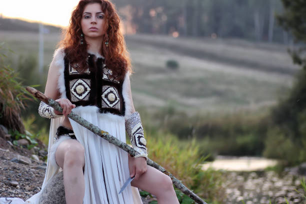 istock girl with spear at the river 657360188