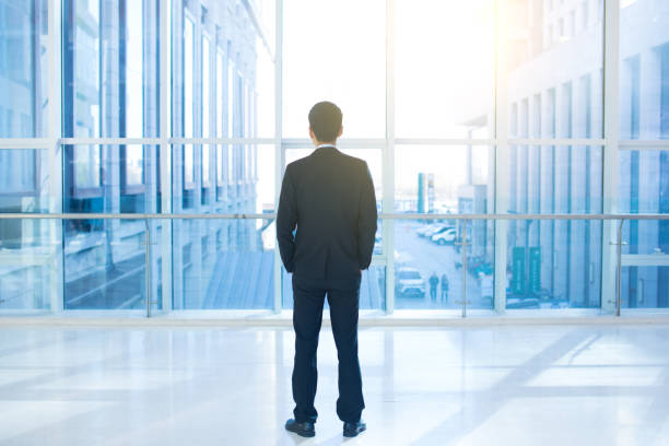 istock Businessman looks out of office window 657360228