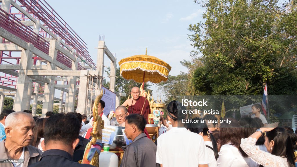 people offering food and items to a buddhist monk people offering food and items to a buddhist monk and being blessed at Sri Don Moon temple  in Chiang Mai, Thailand on February 19, 2017. Adult Stock Photo