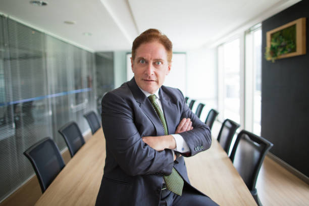 istock Surprised senior businessman sitting in boardroom 657360686