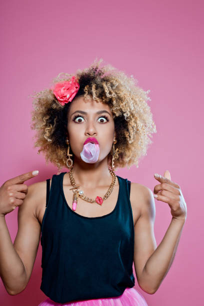 istock Cute afro woman blowing bubble gum 657360872
