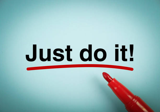 Just Do It Text Just Do It with red underline on the light blue background. just do it stock pictures, royalty-free photos & images