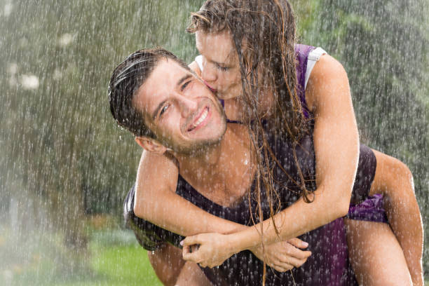 istock Couple playing in the rain 657361394