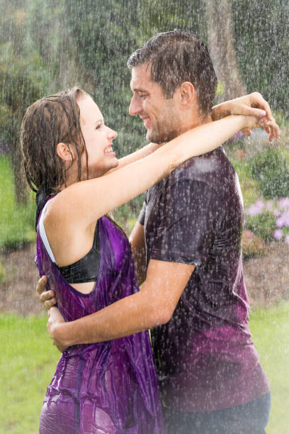 Romantic couple embracing in rain
