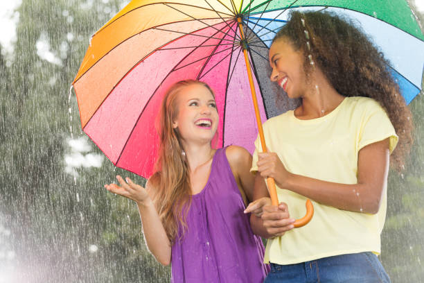 istock Friends walking with colorful umbrella 657361466