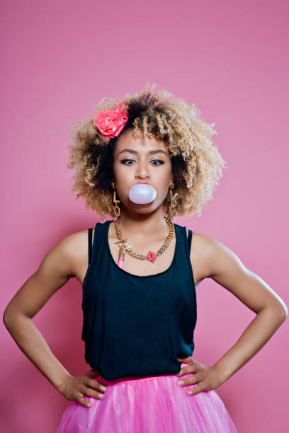 istock Cute afro woman blowing bubble gum 657367860